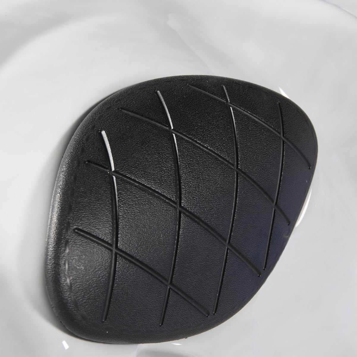 Black leather-look spa pillow with diamond pattern on a white background