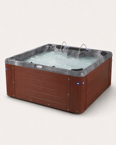 A square hot tub with a brown wood-look exterior and a gray faux-marble interior liner, shown with bubbling water and dual spray nozzles against a light beige background. #cabinet_sonoma-redwood