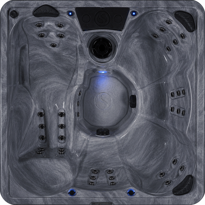 Top view of a hot tub with a gray interior and blue interior light.#seating_lounger