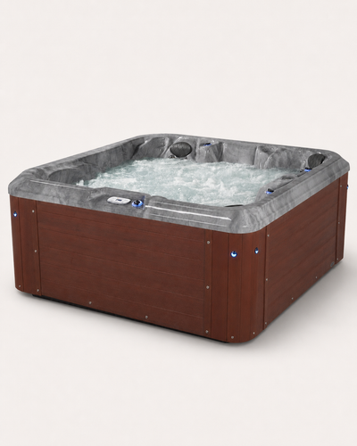 A square hot tub with a brown wood-look exterior and a gray liner, filled with bubbling water, shown on a plain light background.