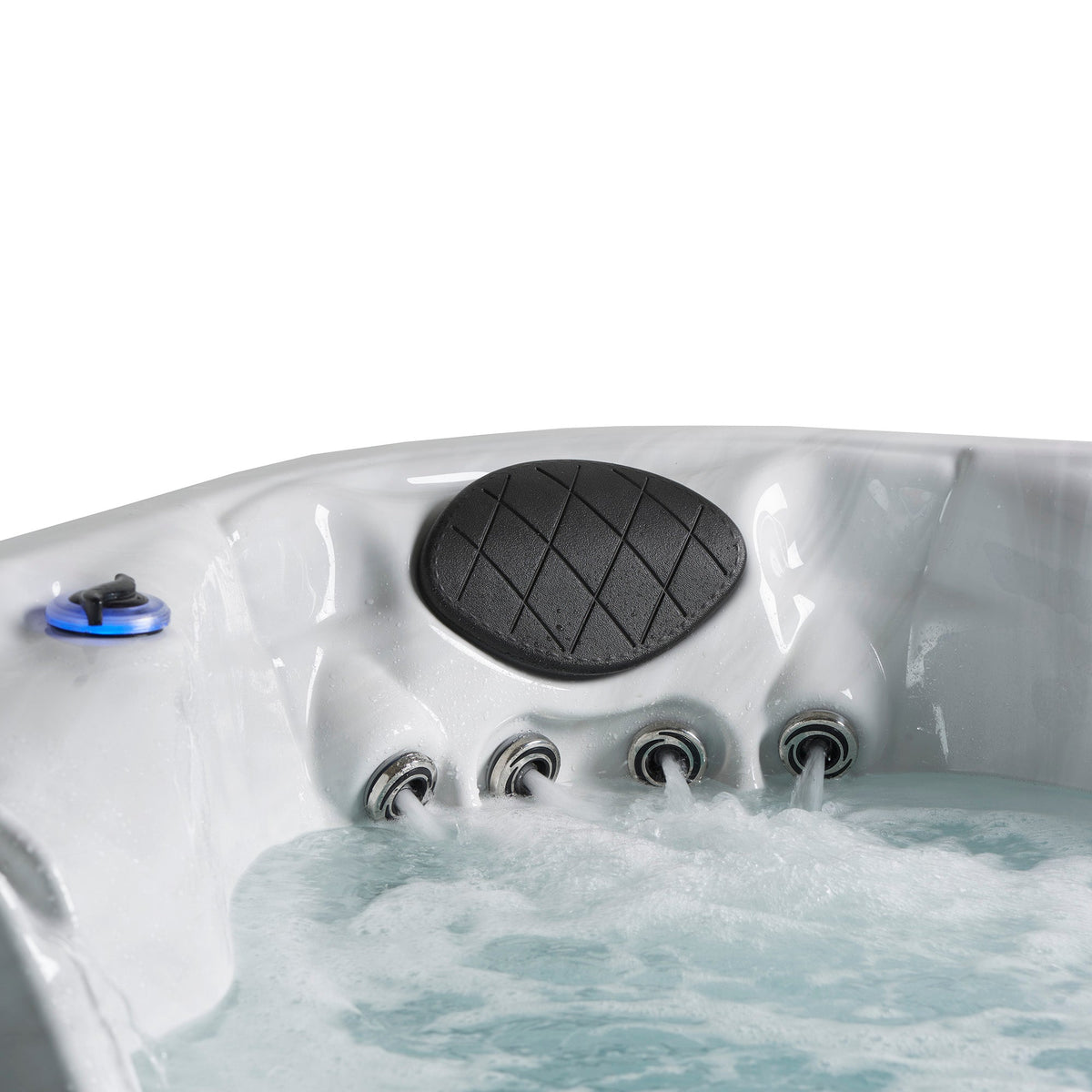 Close-up of a white hot tub with bubbling water, a black oval headrest and multiple jet openings on a white background.