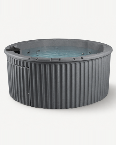 A round gray hot tub with a ribbed exterior and blue-tinted water inside, shown on a plain light background. #color_gray