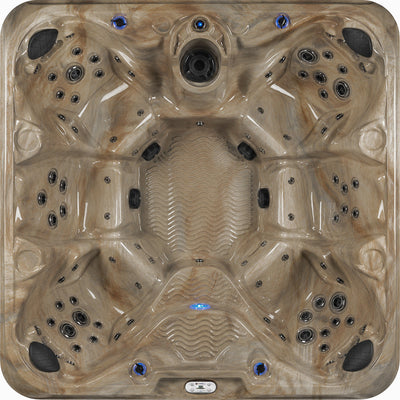 Top view of a beige hot tub with blue lighted controls 