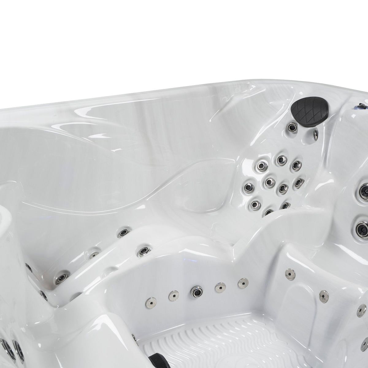 Close-up of a white hot tub with multiple jets.