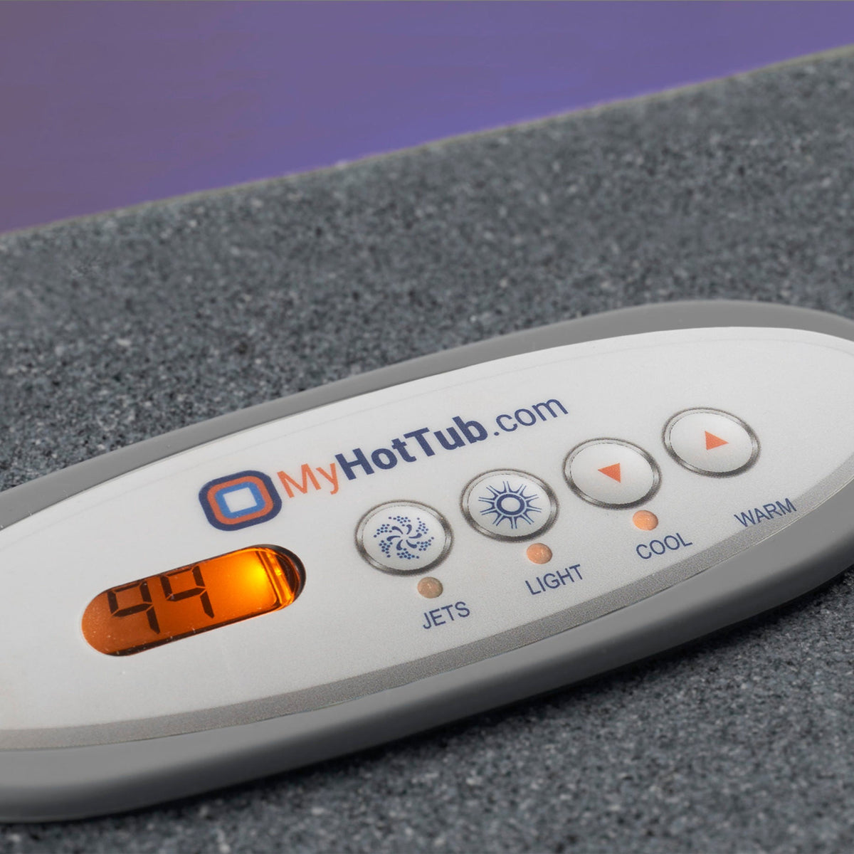 A close-up of a MyHotTub.com digital spa control panel resting on a gray textured surface with a purple background.