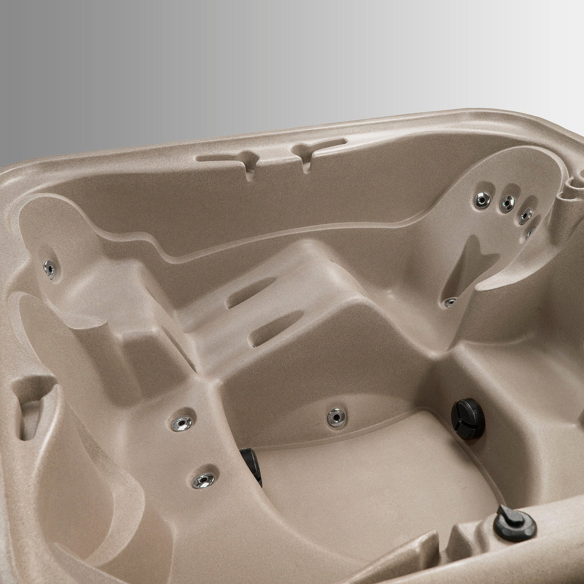 Close-up of a beige hot tub with visible interior design and components.