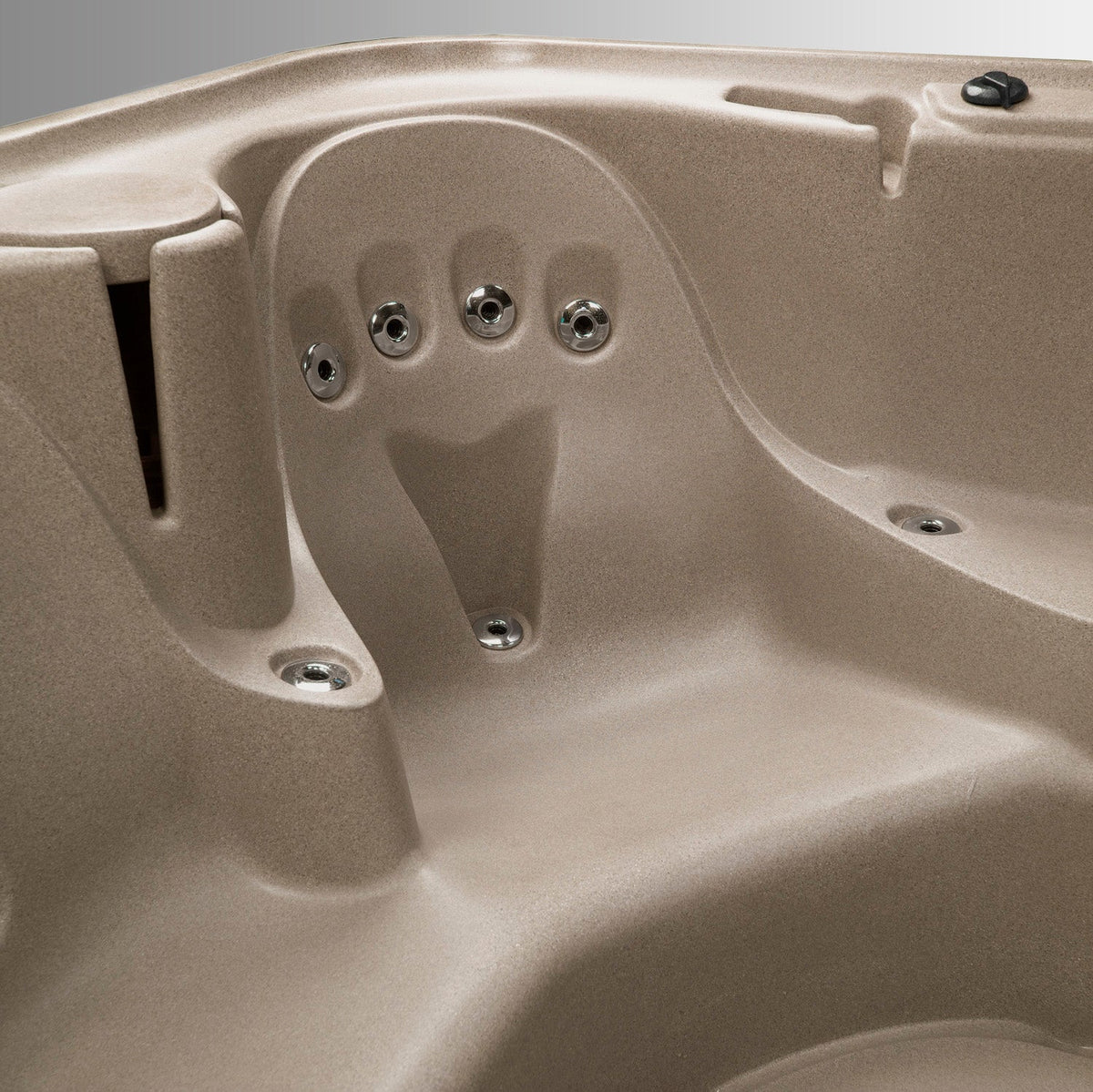 Close-up of a beige hot tub with visible jets.