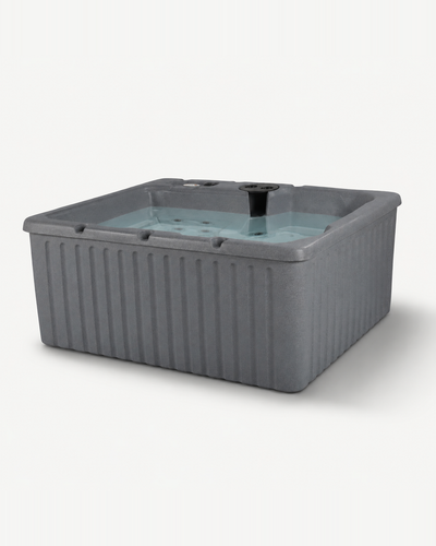 A gray  outdoor hot tub with ribbed sides and a light blue-tinted water surface, shown on a plain light gray background 