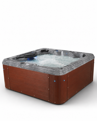 A square hot tub with a brown wood-look exterior and a gray stone-look interior, shown with water jets running in the tub against a white background. 