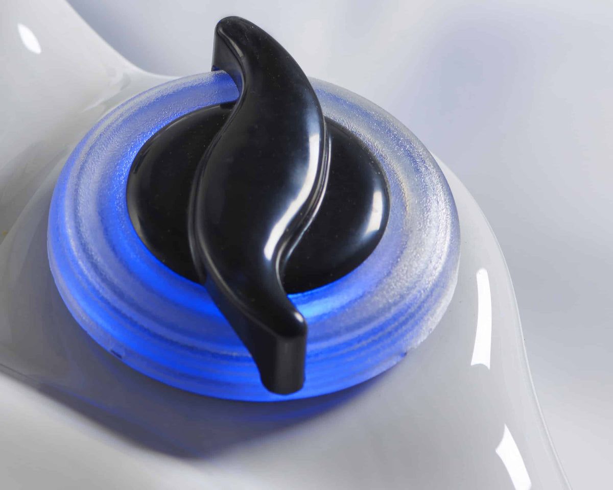 Close-up of an LED control knob on a hot tub with blue light