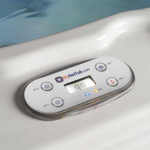 Close-up of a white hot tub control panel with a digital display and buttons, branded MyHotTub.com, mounted on the exterior of a white hot tub.
