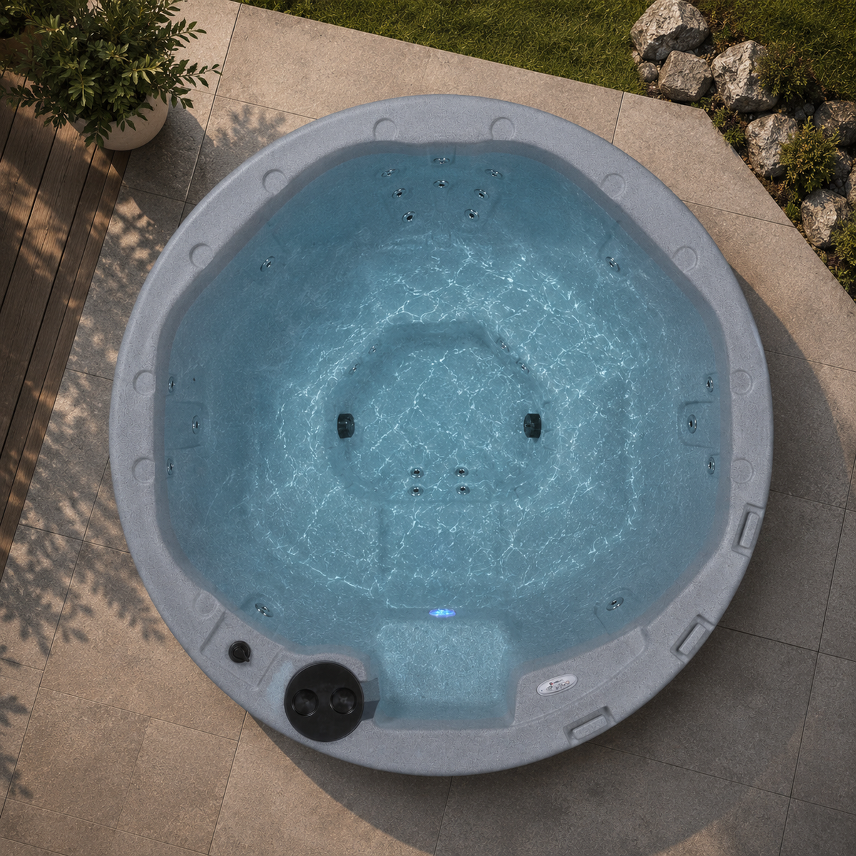overhead view of Corona hot tub on a patio with plants and rocks in the background