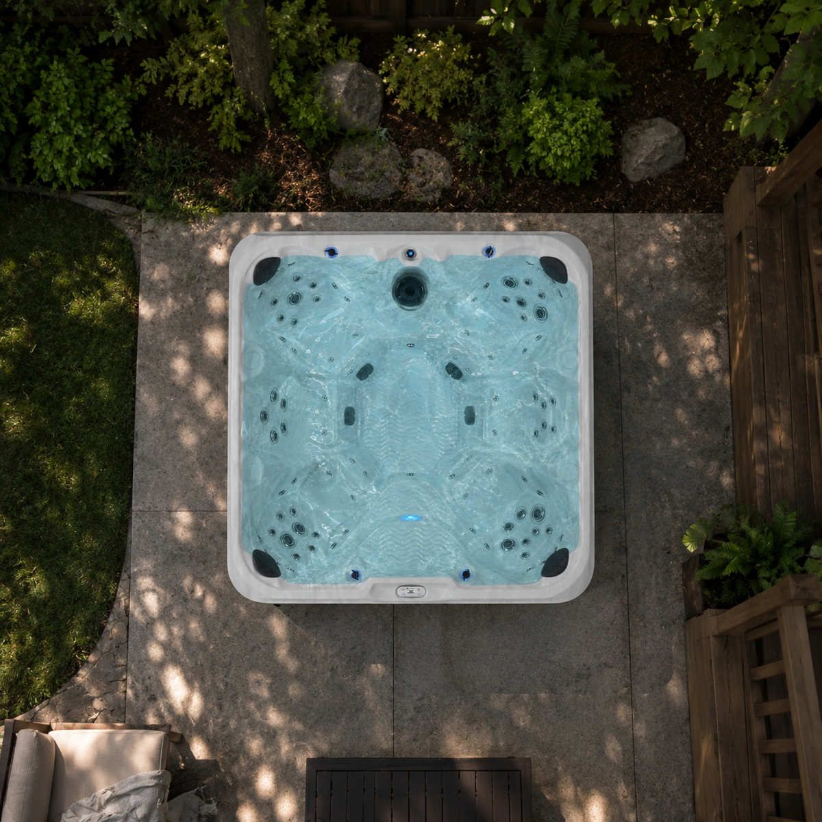 Overhead view of a hot tub in a backyard setting with greenery