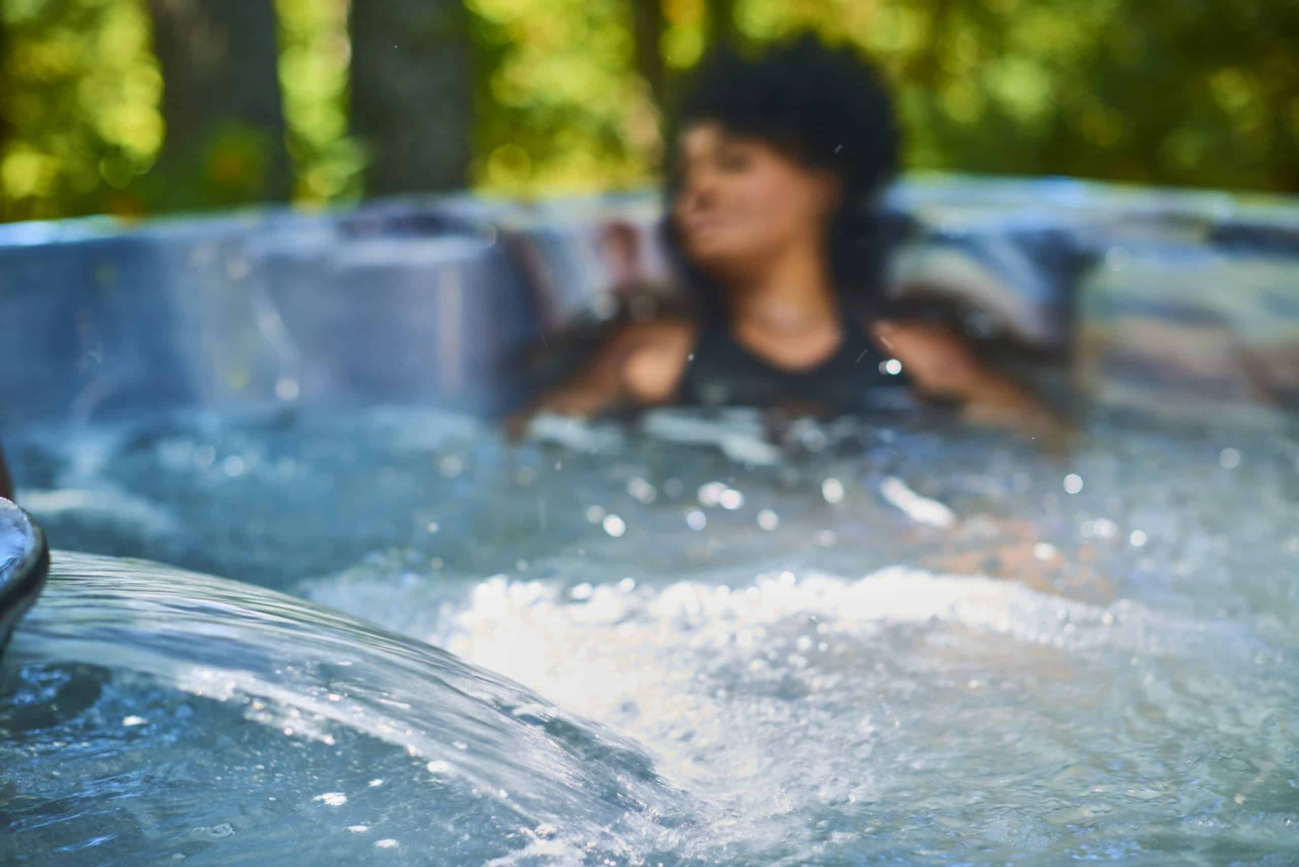 Woman relaxing in hot tub.